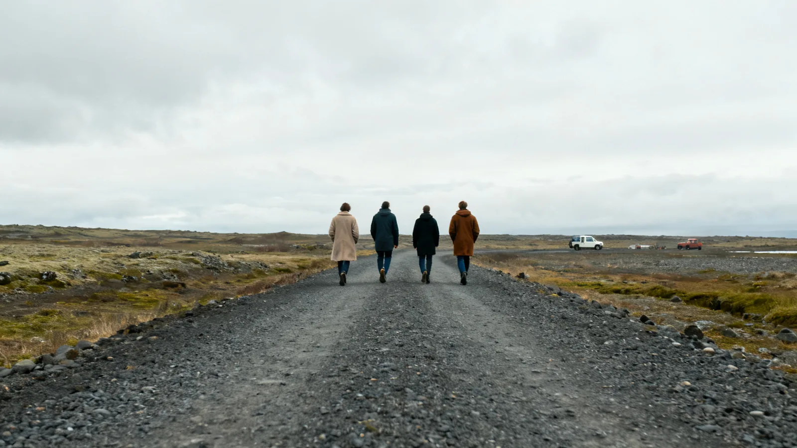 Distant travellers walking along an anonymous rural Icelandic path