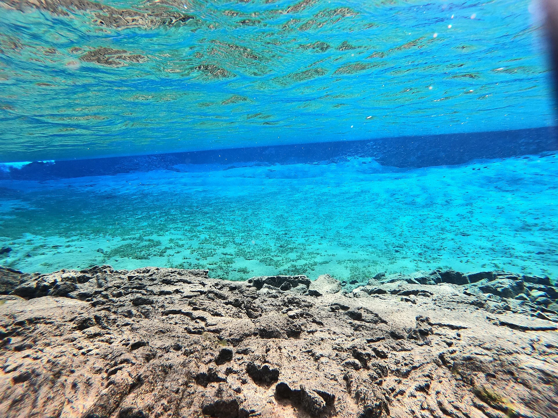 Submerged rocks beneath clear blue water in Silfra Lagoon